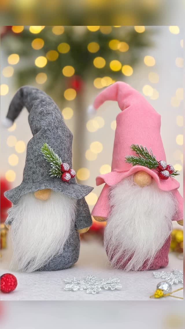 Two fabric gnomes with long white beards and evergreen sprigs on their hats.