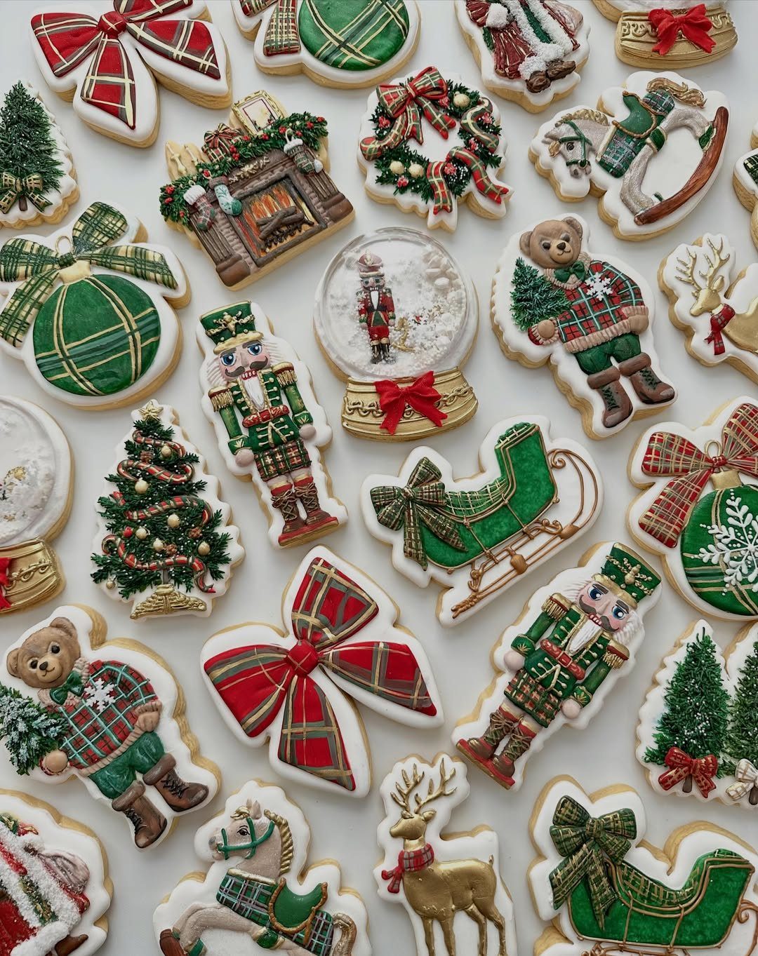 Decorated sugar cookies in various festive shapes including nutcrackers, trees, and ornaments on a white background.