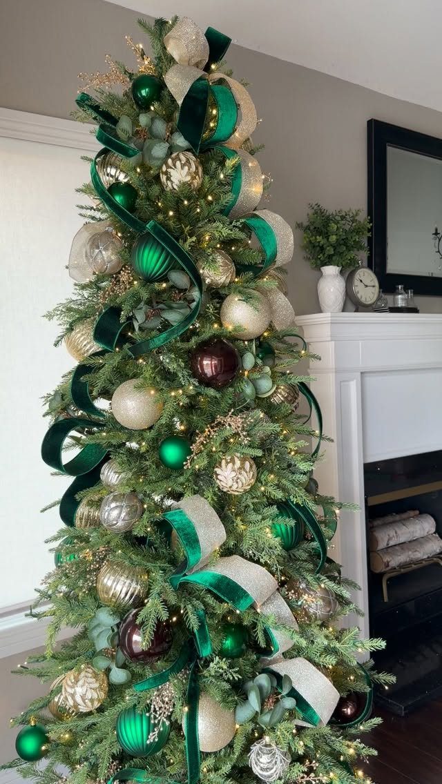 A decorated Christmas tree with green velvet ribbons, gold ornaments, and warm white lights.