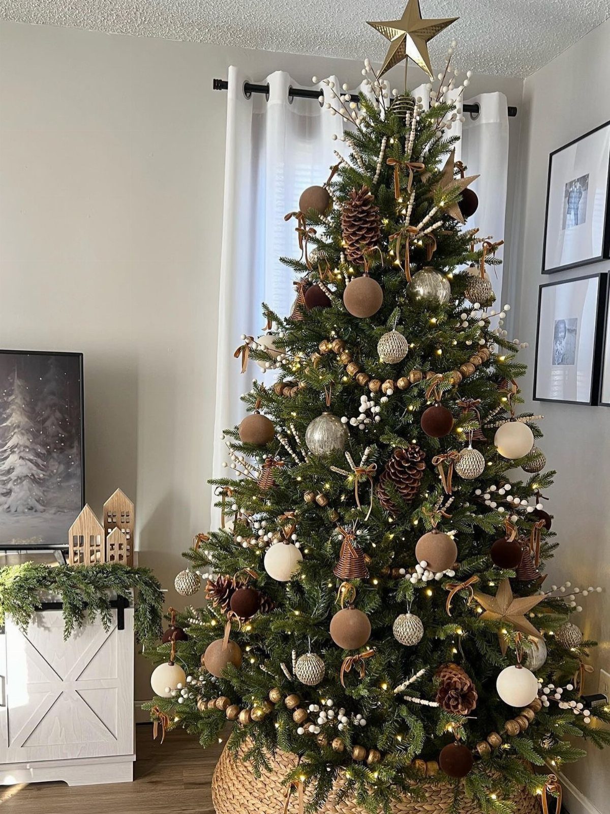 Decorated Christmas tree with brown, cream, and silver ornaments and a gold star topper.
