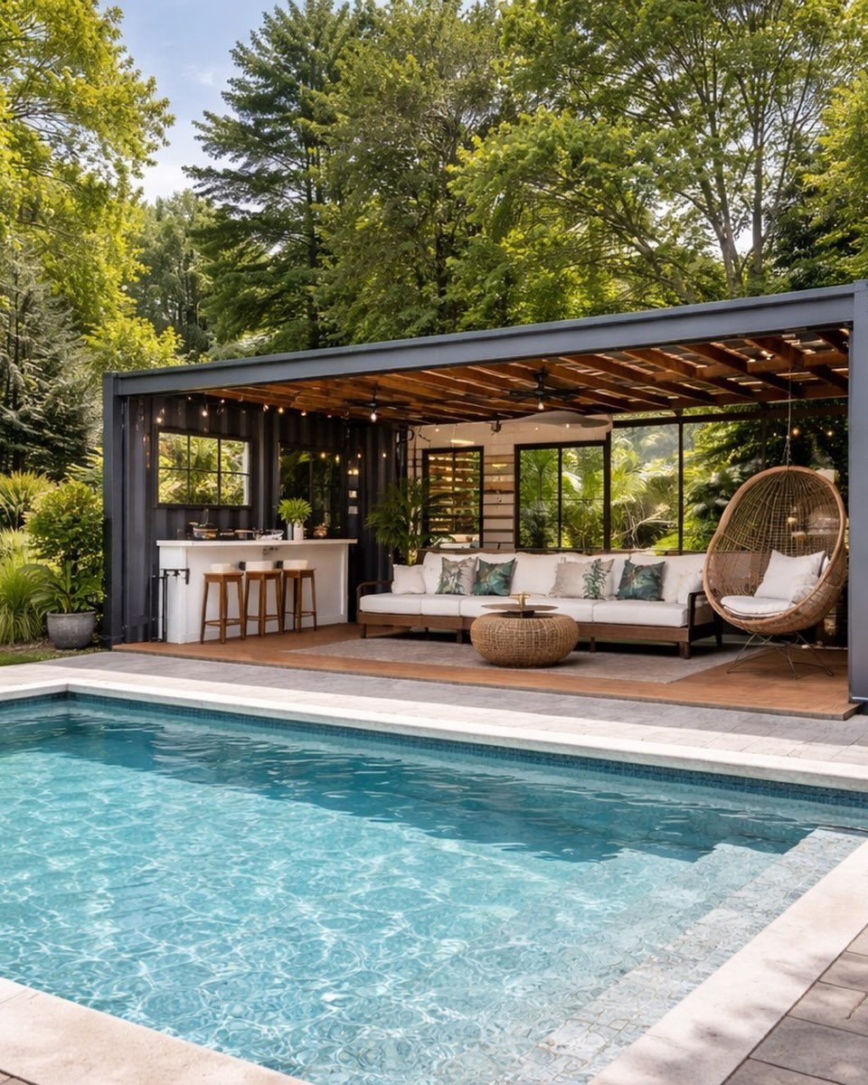 Modern covered patio with outdoor furniture and a bar area situated next to a swimming pool.