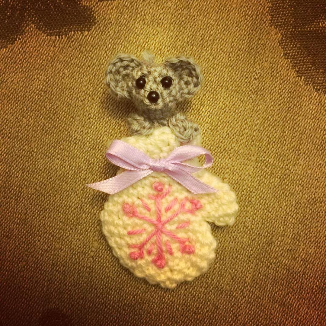 Crochet Christmas Ornaments: 19 Free Patterns for 2026 10 Crochet mitten ornament with a grey mouse head and pink snowflake embroidery.