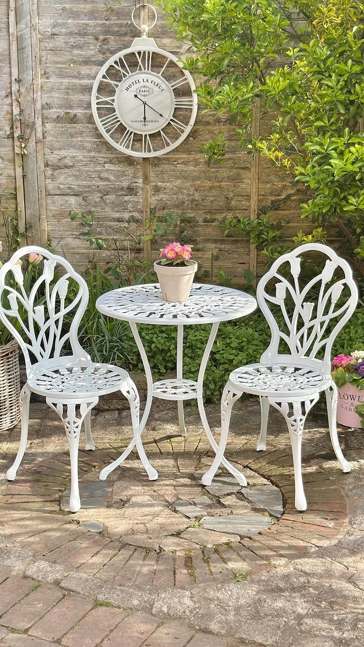 Decorating a Patio: 10 Ideas for a Space You Actually Use 3 White metal bistro set with ornate leaf patterns on a brick patio in a garden.
