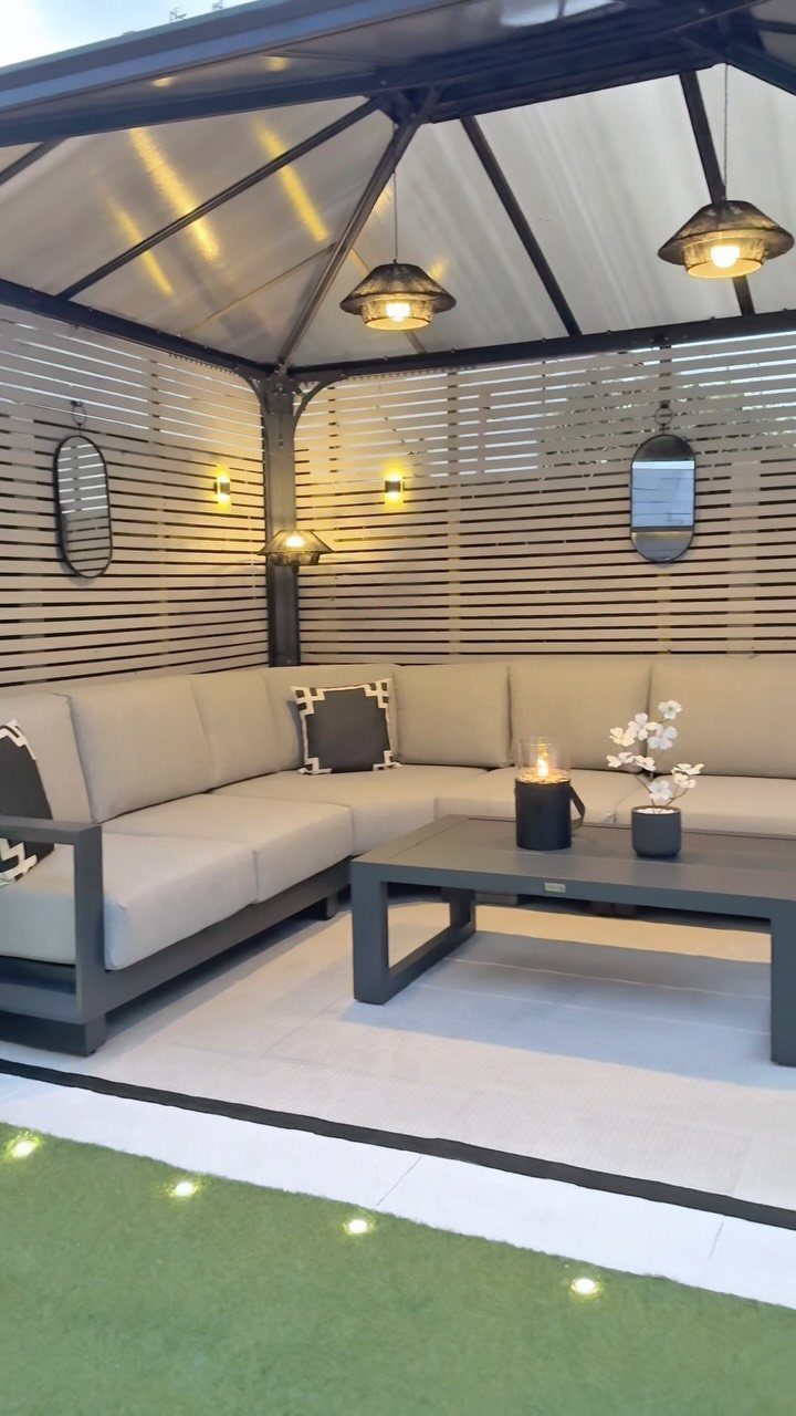 Decorating a Patio: 10 Ideas for a Space You Actually Use 9 Grey L-shaped outdoor sectional sofa and coffee table under a modern gazebo structure.