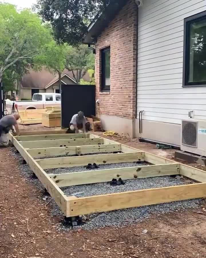 DIY Modern Shed: 19 Plans for Every Yard and Budget 11 Wooden foundation frame being constructed on a gravel base next to a residential house.