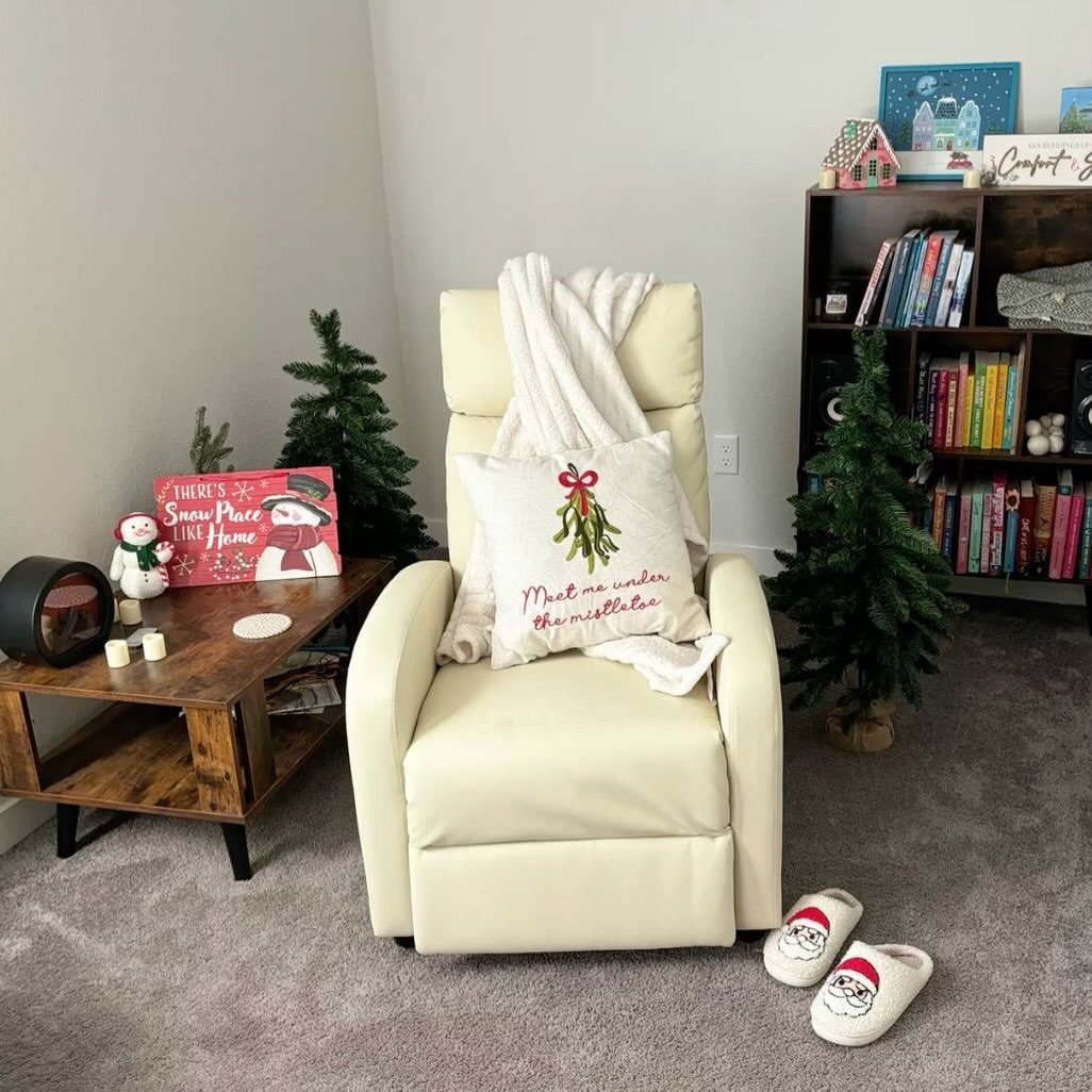 Fun Christmas Activities for Families: 18 Ideas With Photos 7 Cream recliner with festive pillow and blanket, surrounded by Christmas decor and books.