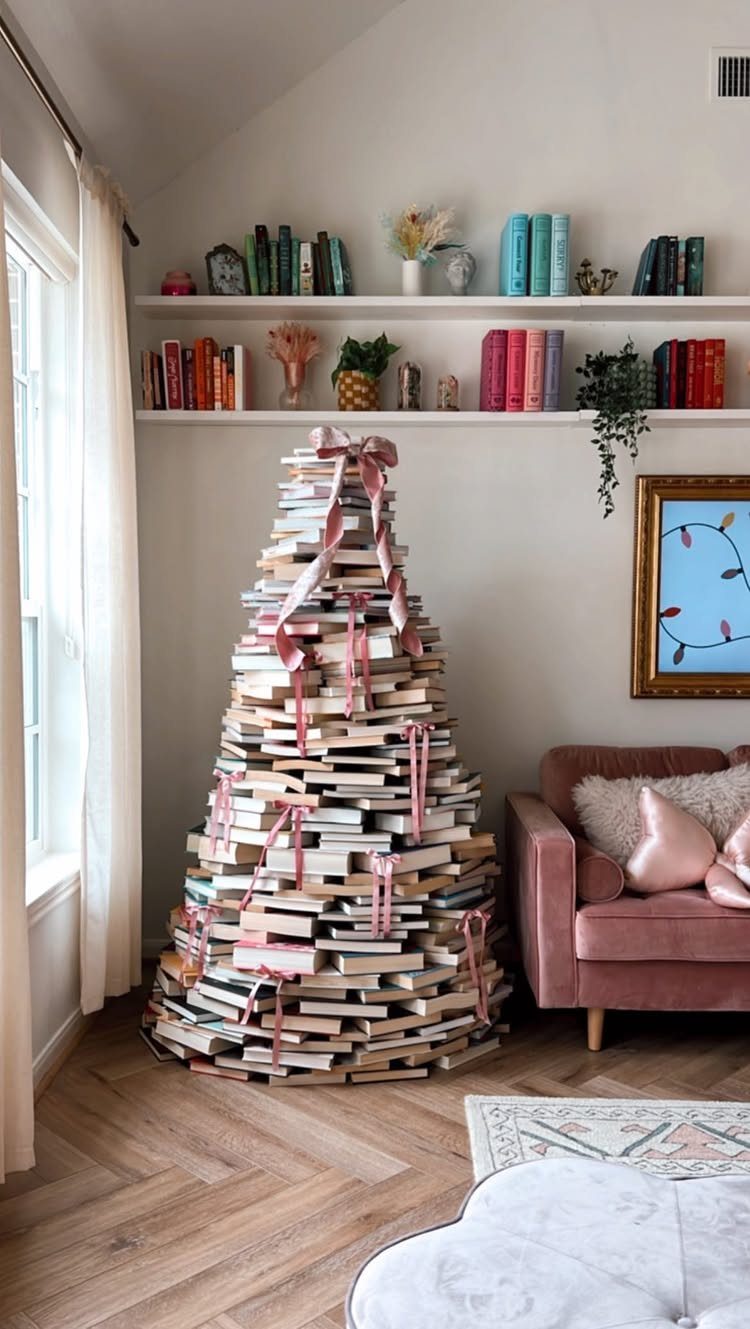 Fun Christmas Activities for Families: 18 Ideas With Photos 15 A Christmas tree constructed from stacked books decorated with pink ribbons in a bright living room.
