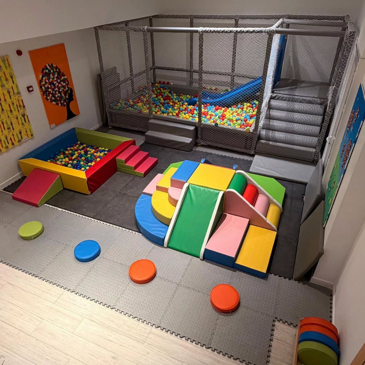 17 Garage Playroom Ideas for Safe, Creative Kid Space 17 Colorful foam climbing blocks and a ball pit in a large indoor children's play area.