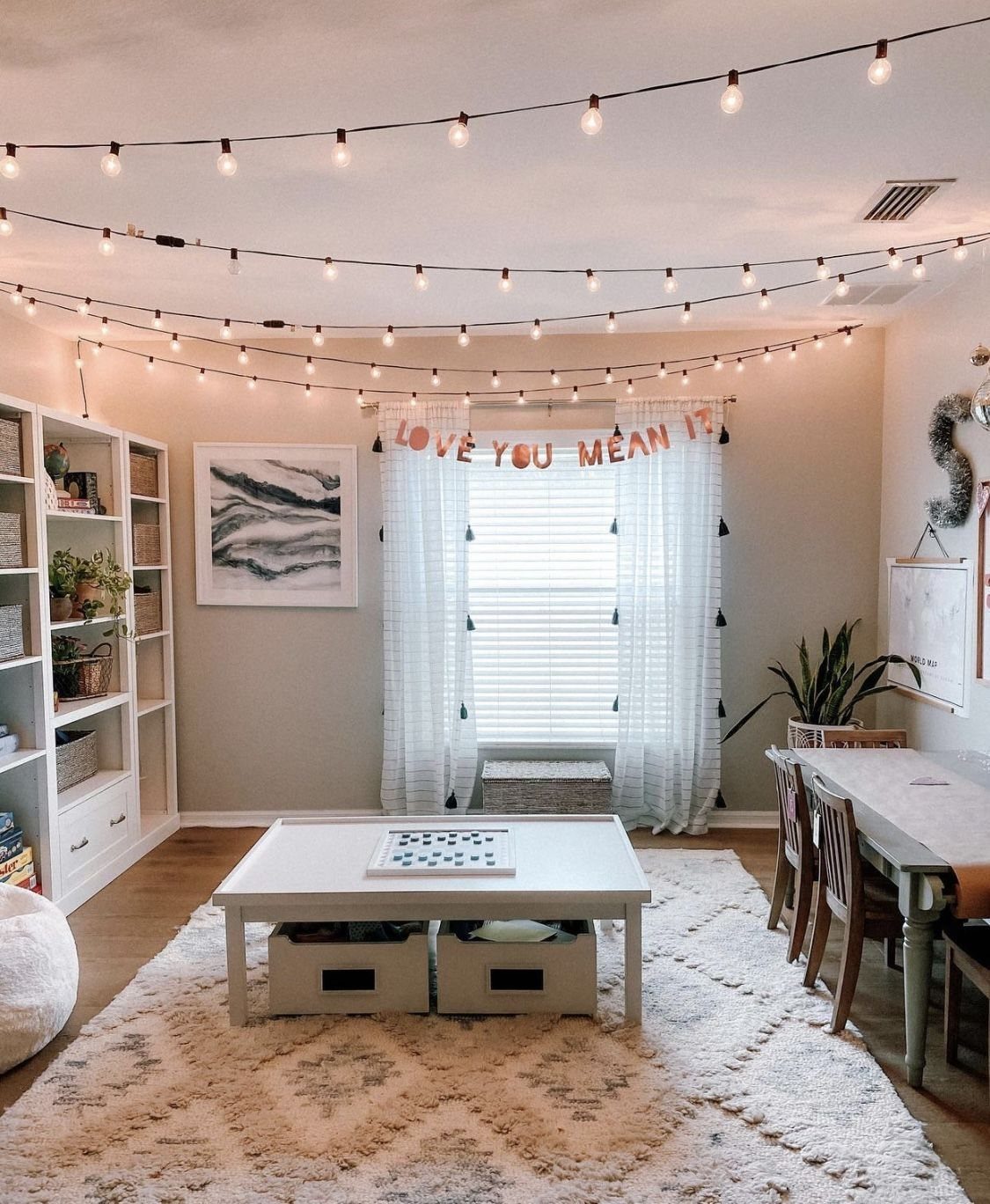 17 Garage Playroom Ideas for Safe, Creative Kid Space 13 Warm string lights draped across the ceiling of a cozy, well-lit playroom.