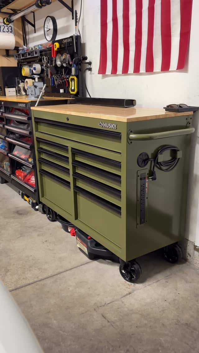 Garage Tool Setup: 8 Ideas That Actually Save Space and Time 7 Olive green Husky rolling tool chest with a wooden workbench top in a garage setting.
