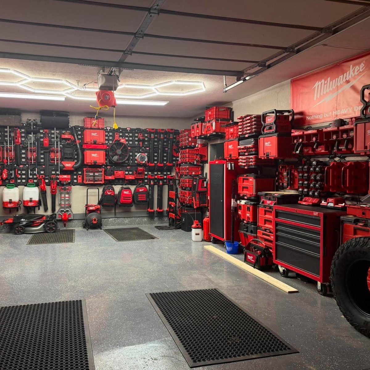 Garage Tool Setup: 8 Ideas That Actually Save Space and Time 3 Red toolboxes and organized power tools mounted on walls in a clean garage workspace.