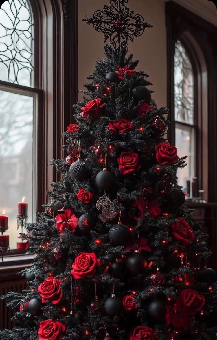 Black Christmas tree decorated with large red roses and black ornaments near arched windows.