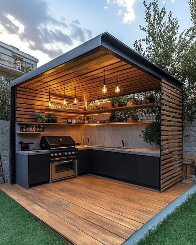 14 Outdoor Built In Grill Ideas for Every Backyard Style 6 Modern outdoor kitchen with a built-in grill under a stylish wooden slat ceiling structure.