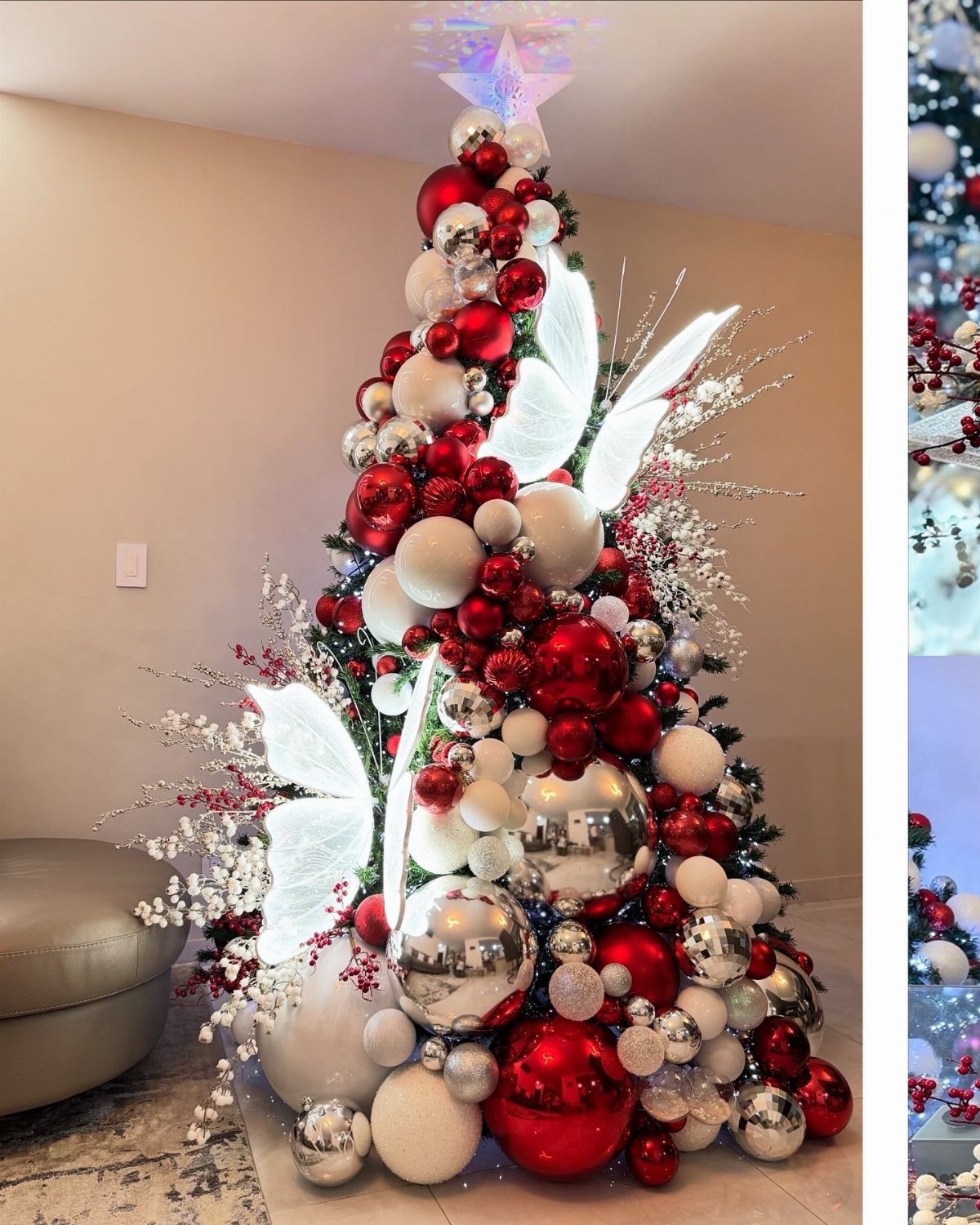 A Christmas tree decorated with large red, white, and silver ornaments and white butterfly decorations.